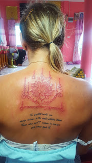 A female traveller showing her finished Sak Yant tattoo — a real female Sak Yant experience